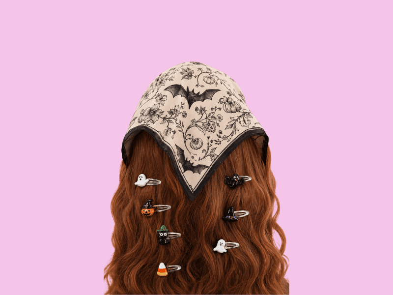 Cute Halloween resin hair clips with ghosts, pumpkins, bats and candy corn styled in red hair with a spooky floral headscarf.