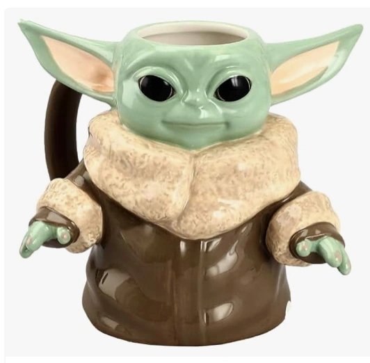 Green alien character novelty mug with large ears, black eyes and brown robe.
