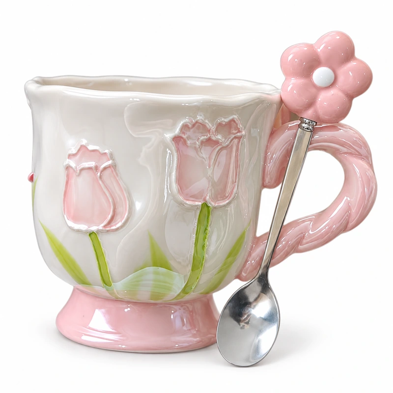 Pink floral ceramic coffee mug with raised tulip design and matching flower spoon.