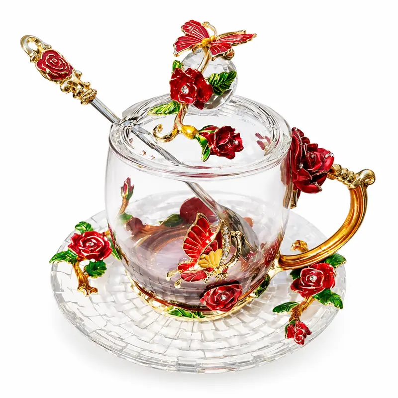 Clear glass tea cup set with red roses, gold handle, butterfly details, lid, spoon and saucer.
