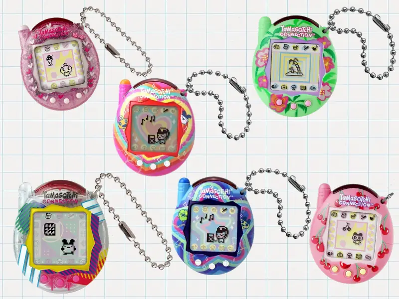 Six Tamagotchi Connection devices in pink, green, blue and rainbow shell designs