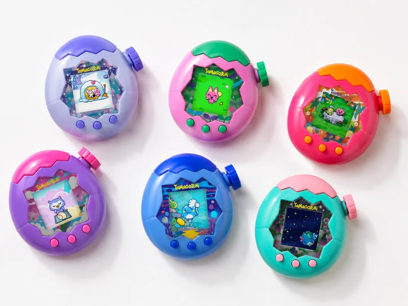 Six colorful Tamagotchi Paradise virtual pets with Zoom Dials on a white background