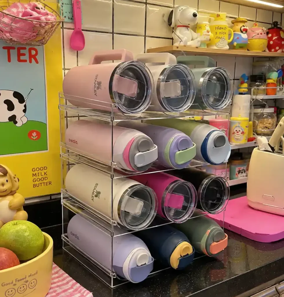 Stackable water bottle organizer holding Stanley and Owala tumblers on a kitchen countertop
