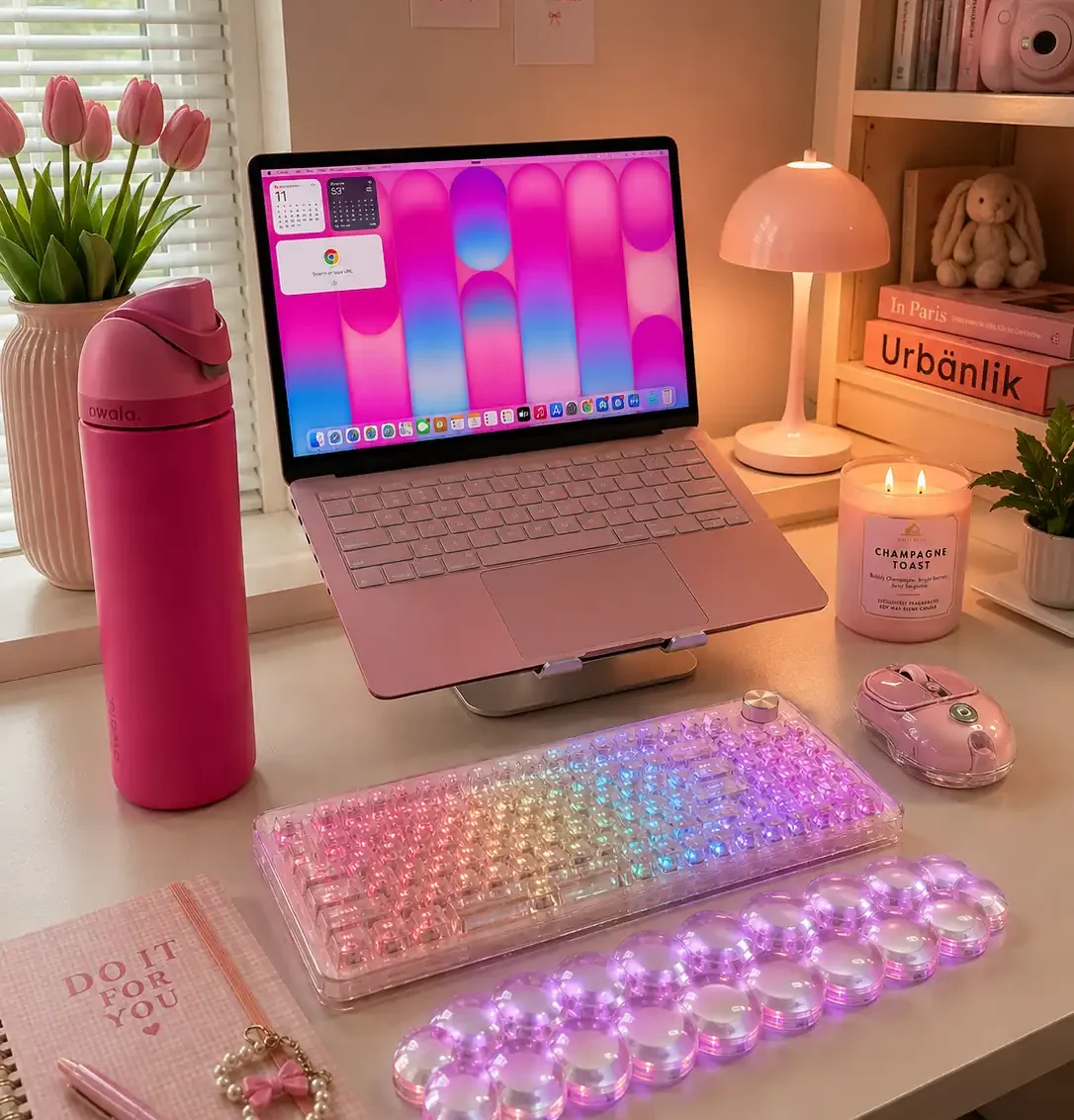 Cute YUNZII X98 keyboard with RGB lighting in a pink desk setup with laptop and matching accessories